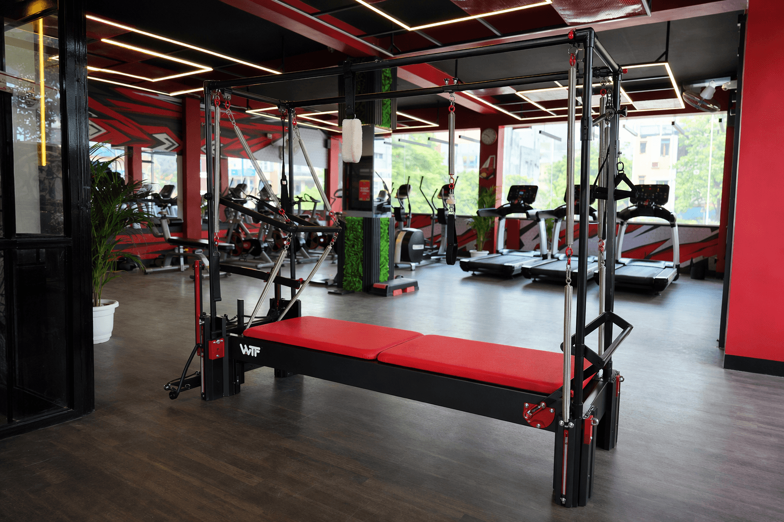 Pilates Cadillac with Reformer deployed in a WTF gym